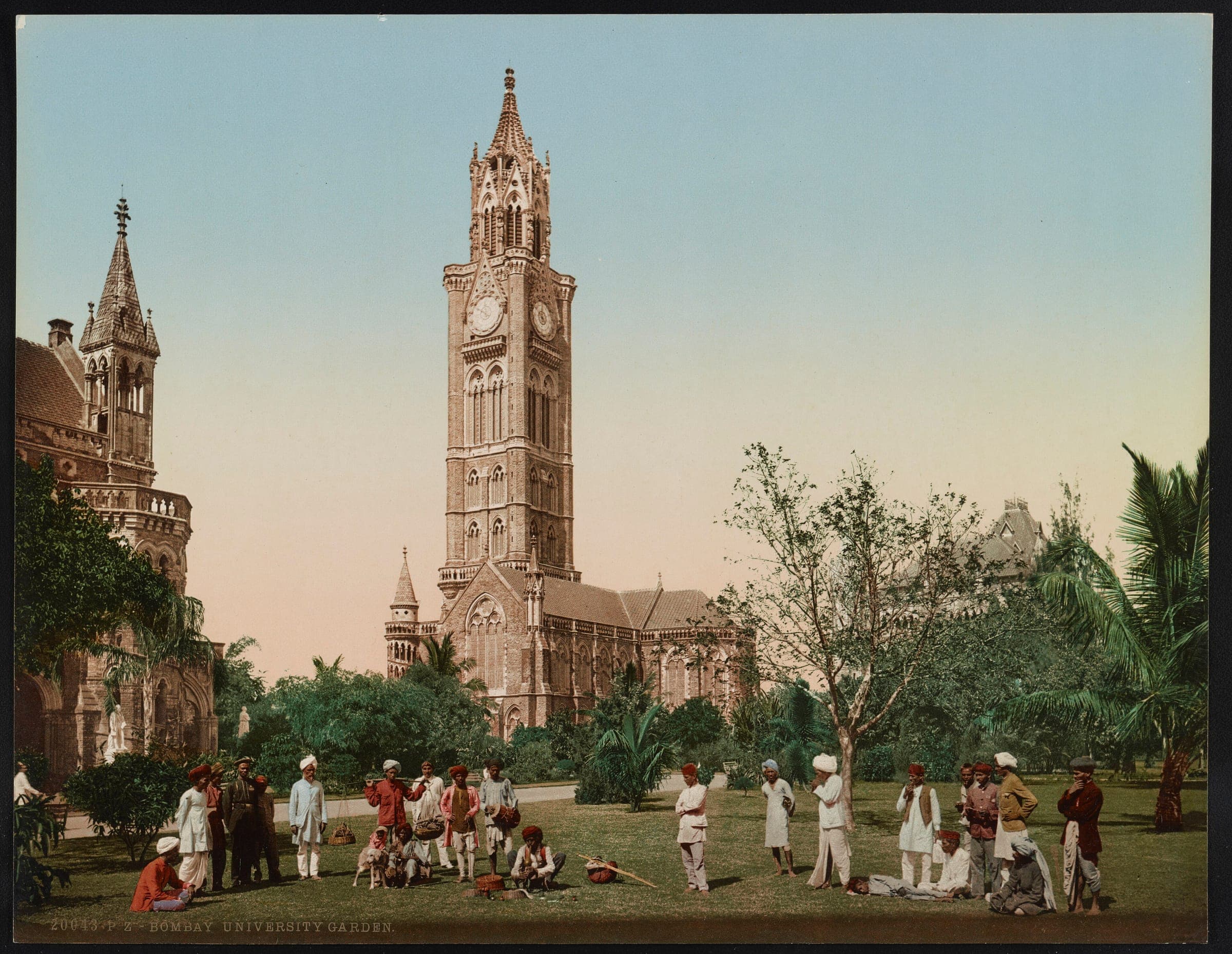 The Rajabai Clock Tower rising over the University gardens in the 1890s, with a crowd on the lawn